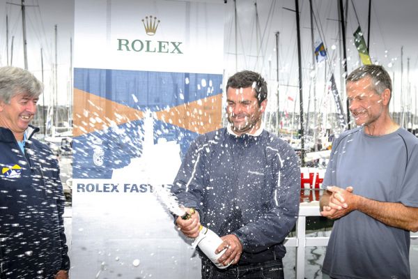 L-R: The RORC CEO Eddie Warden Owen congratulates IRC Overall winners of the 2013 Rolex Fastnet Race, Alexis and Pascal Loison. Photo: Rolex/Kurt Arrigo