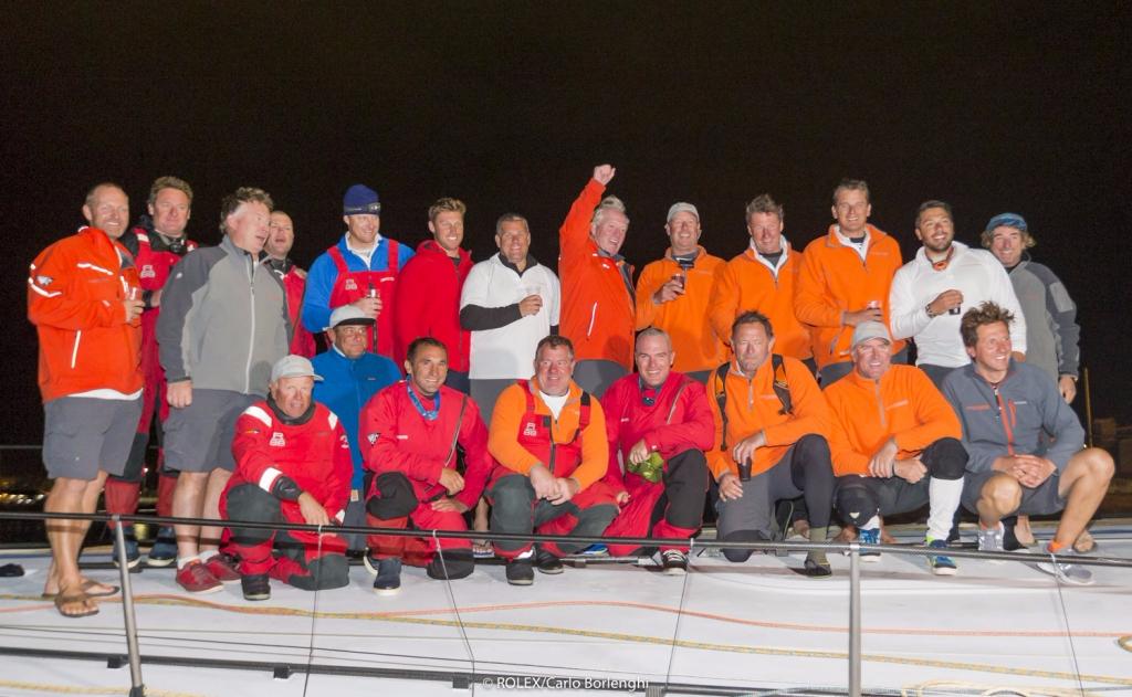 Rambler 88 crew celebrating their monohull line honours victory in the Rolex Fastnet Race © Rolex/Carlo Borlenghi