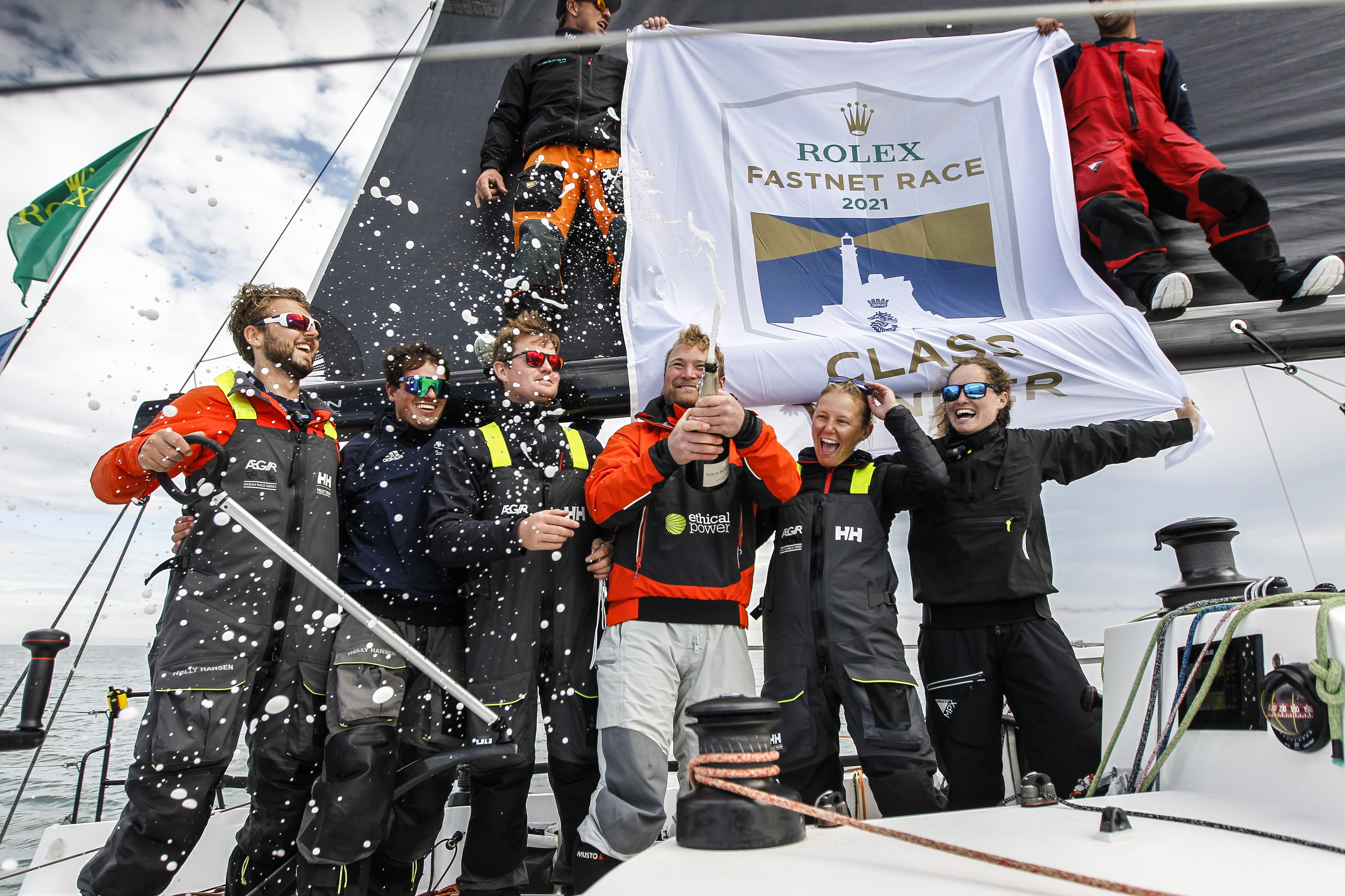 Tor Tomlinson (2nd right) on board Sunrise after finishing the 2021 Rolex Fastnet Race © Paul Wyeth/pwpictures.com