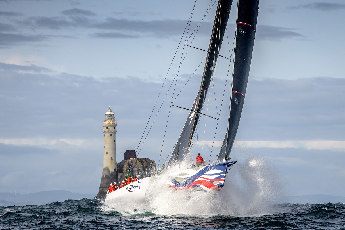 Wizard - 2019 Rolex Fastnet Race winner launches off a wave shortly after passing he Fastnet Rock and heading to the finish  © Kurt Arrigo/ROLEX