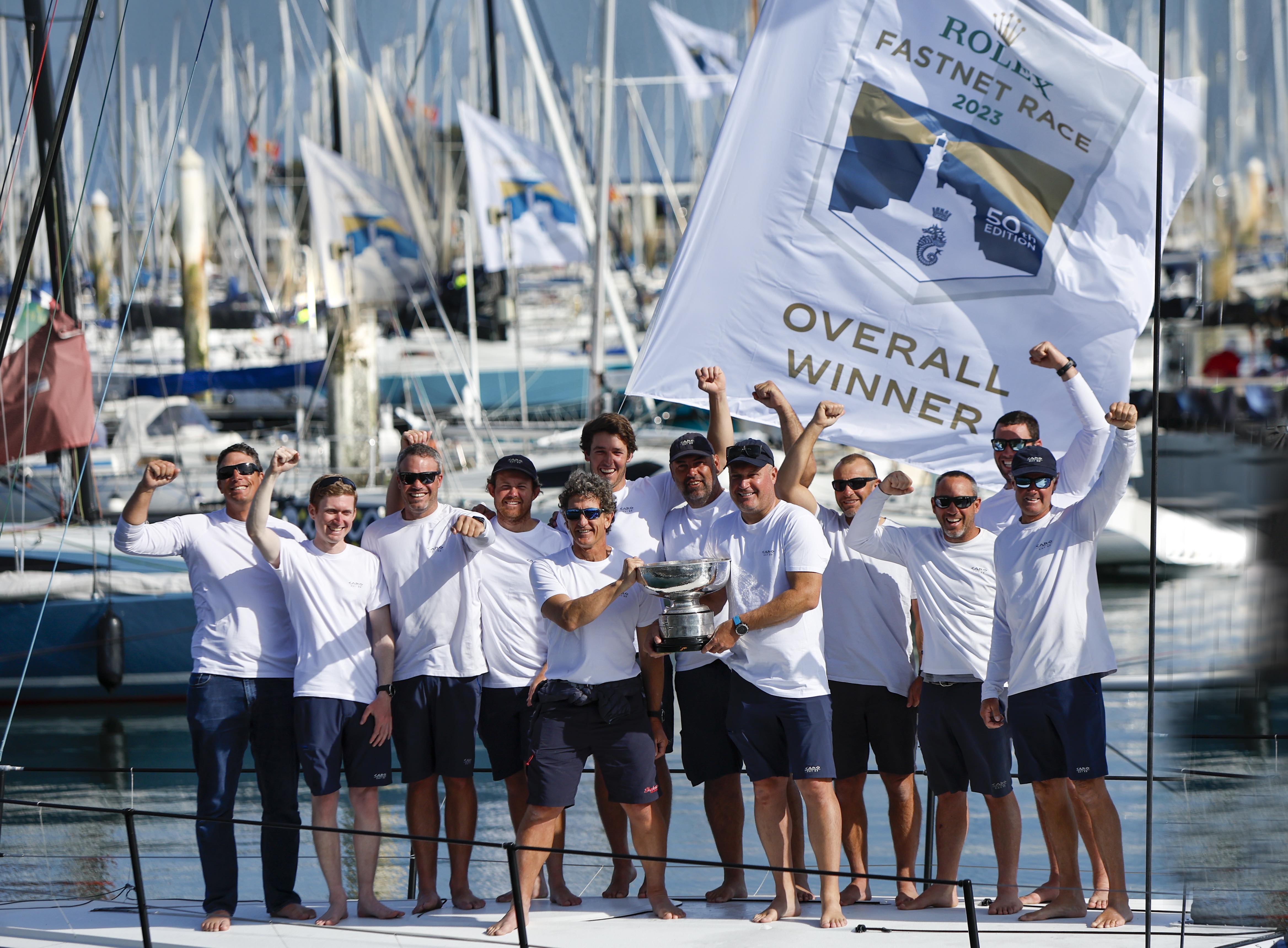 Max Klink (right) and tactician Adrian Stead (left) plus the Caro crew with the Rolex Fastnet Race overall winner's trophy - the Fastnet Challenge Cup ﻿© Paul Wyeth/pwpictures.com