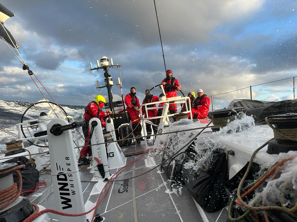 Powering through the waves on board VO65 Wind Whisper