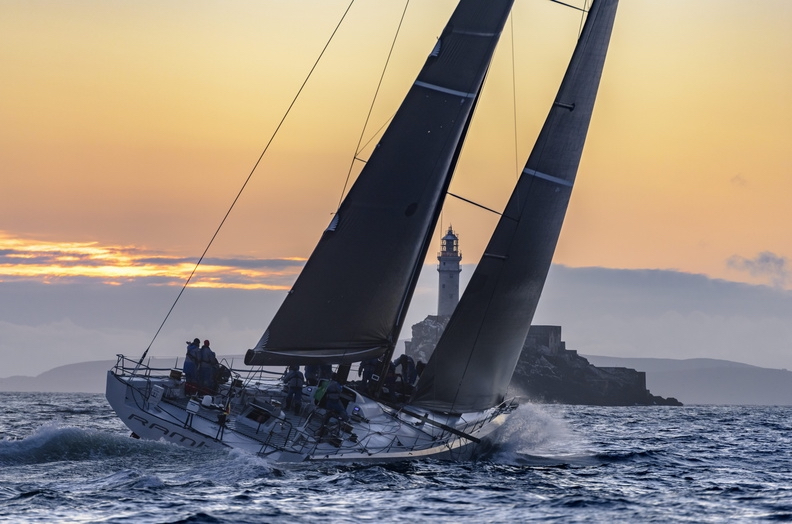 Rambler 88 rounds the Fastnet Rock. She returns this year rechristened Lucky © ROLEX/Kurt Arrigo